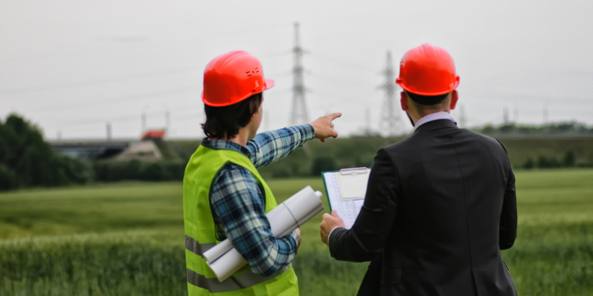 two contractors looking at land for solar